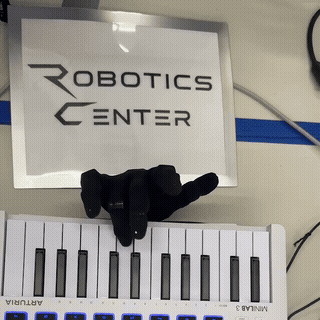 Dexterous hand playing three notes on a MIDI keyboard